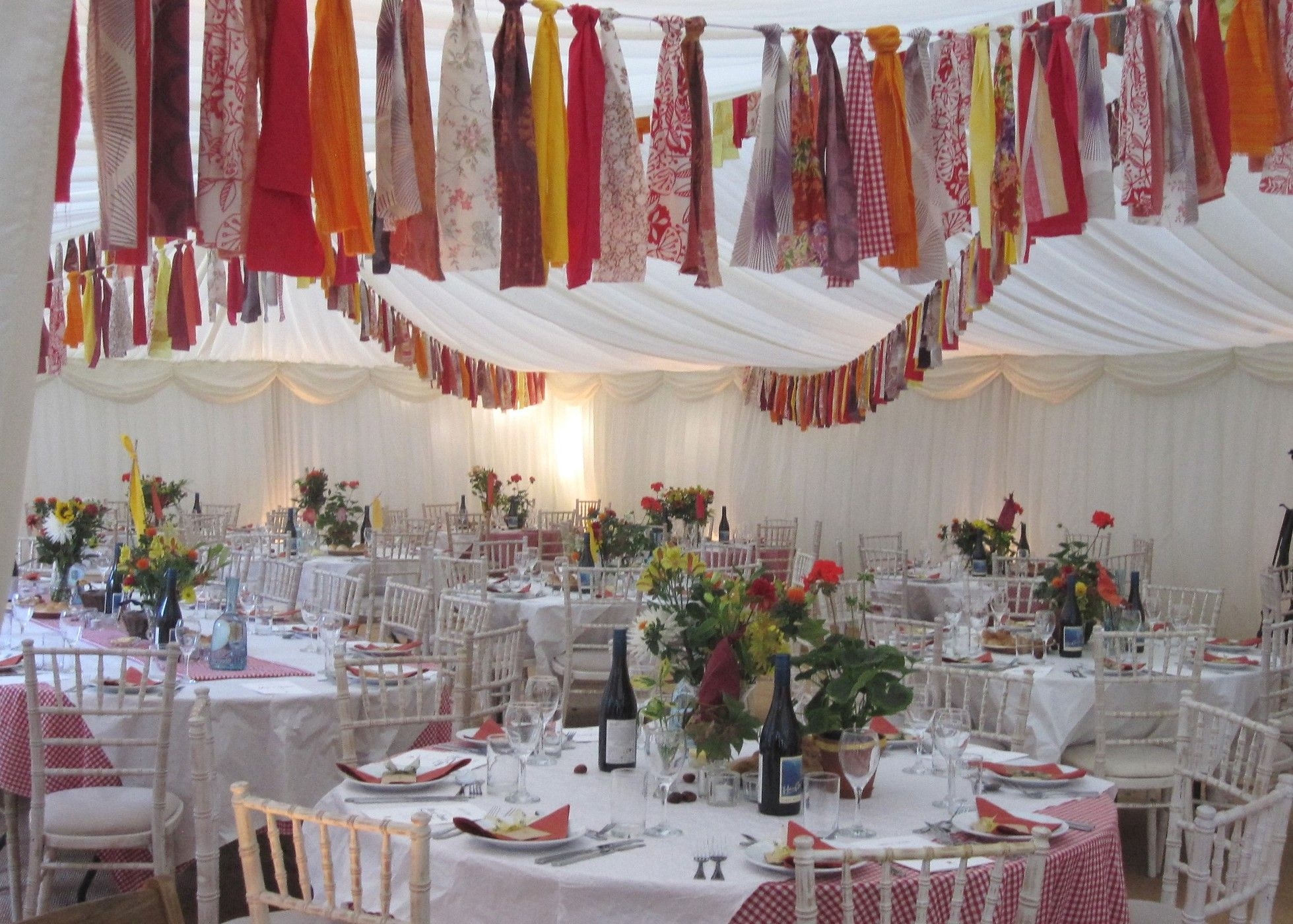 Interior view of marquee with nepalese-inspired prayer flag bunting